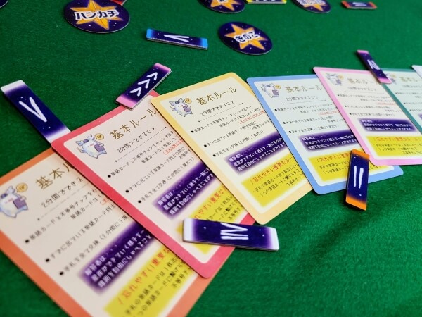 SIGN's player cards fanned out with tokens scattered over them