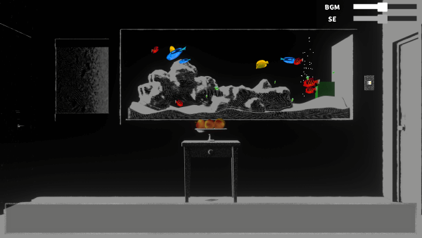 Colorful fish in a tank, set in a dark room. There is a small table in front of the tank with three round objects.