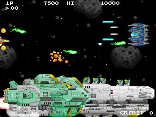Player ship exploding while an enormous green battleship passes underneath and a round blue fighter ship shoots at the player in INFINOS EXTRA STAGE